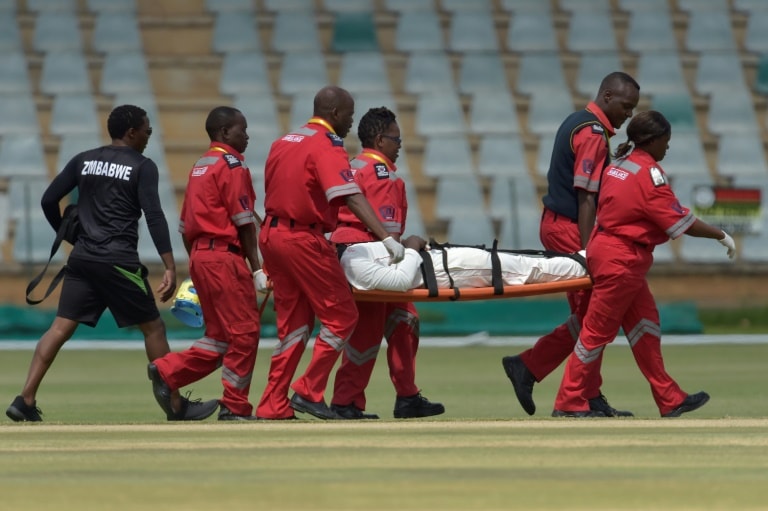 Zimbabwe's Kevin Kasuza is carried off the field after being hit on the helmet fielding close to the wicket